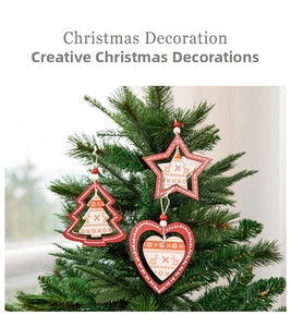 Detail of wooden Christmas ornaments with reindeer and snowflake patterns hanging on tree