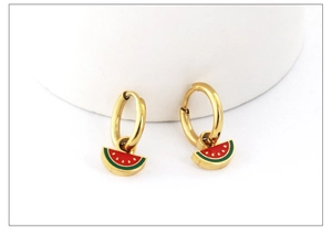 Detailed view of gold hoop earrings with red and green watermelon fruit charms