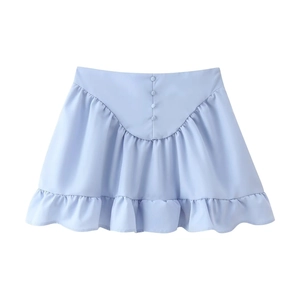 Close-up of light blue mini skirt with decorative buttons and ruffled hem details