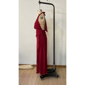 Side view of wine red halter maxi dress with cascading ruffles and high slit detail
