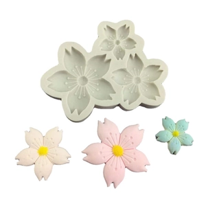 Cherry blossom silicone mold with pink and blue floral fondant decorations for cake baking