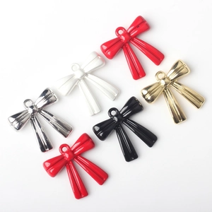 Colorful alloy bow pendants in red, gold, and black for DIY jewelry making