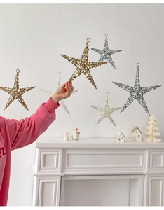 Three metallic five-pointed star ornaments in gold, silver and white for holiday decoration
