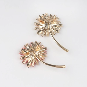 Detail view of flower brooch back with golden plating and secure safety pin closure