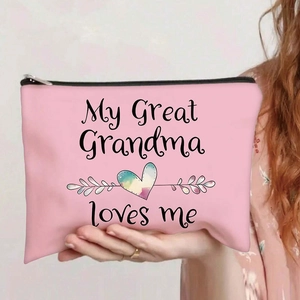 Pink canvas cosmetic bag with rainbow heart print held by hand showing zipper detail
