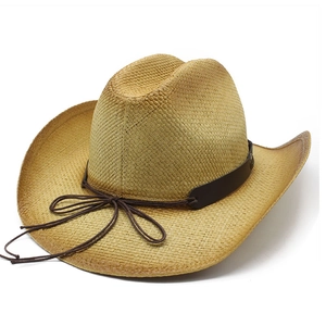 Detail of woven straw cowboy hat featuring brown leather band and intricate natural texture