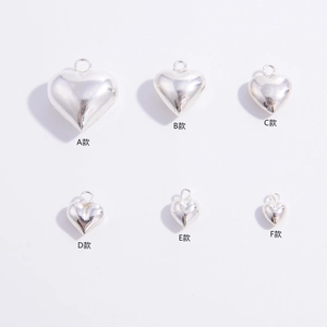 Six sizes of polished S925 sterling silver heart pendants on white background