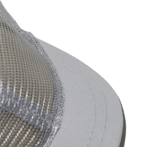Macro shot of breathable grey mesh fabric and reinforced stitching on a baseball cap