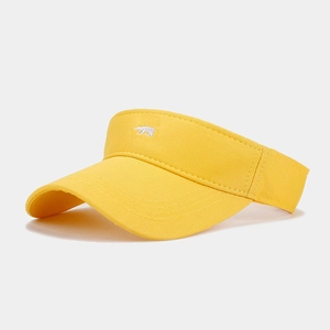 Close-up of bright yellow sun visor hat with white bear embroidery and stitching detail