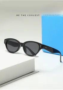 Close-up of black cat-eye sunglasses with polished frames and silver stud details