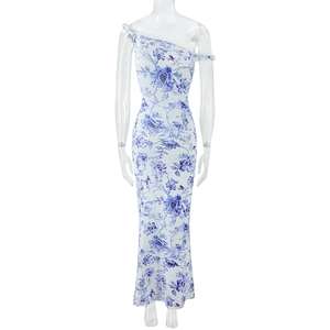 Detail shot of white slim-fit maxi dress featuring blue floral print and one-shoulder design