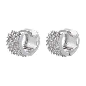 Macro detail of silver huggie earrings with pavé set cubic zirconia rows and sturdy clasp