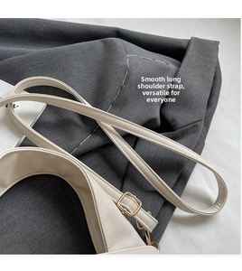 Detail of adjustable litchi texture faux leather shoulder strap with gold-tone hardware