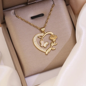 Detail of 18K gold heart pendant with white opal butterfly and rose in gift box