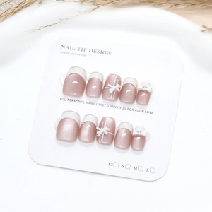 Pink cat eye press-on nails with 3D bows and silver French tips on display card