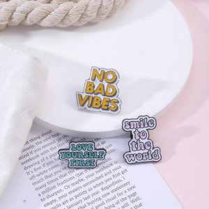 Three colorful enamel pins with motivational quotes NO BAD VIBES and LOVE YOURSELF FIRST