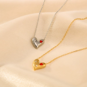 Gold and silver asymmetrical heart necklaces with red enamel and rhinestones on silk