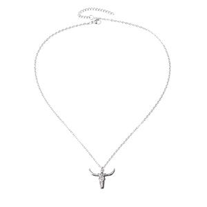 Detailed close-up of a silver bull skull pendant necklace with a delicate steel chain link