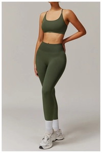 Olive green high-waisted seamless yoga leggings and matching sports bra set on model