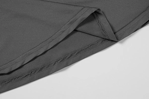 Detailed close-up of double-needle stitching on grey long sleeve bodysuit hem and fabric