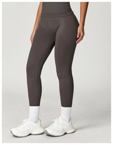 Deep brown high-waisted seamless yoga leggings paired with white socks and sneakers