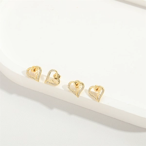 Delicate gold heart stud earrings with sparkling crystals in a minimalist jewelry design
