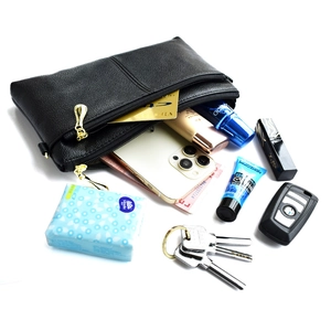 Elegant black lychee leather crossbody bag with gold zippers shown with high capacity