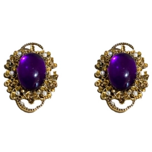 Vintage gold oval purple gemstone clip earrings with small pearl accents on white background