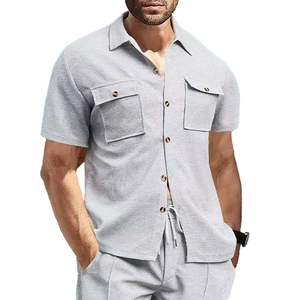 Detail of light grey waffle knit texture on men shirt with breast pockets and buttons
