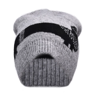 Close-up of grey knitted beanie featuring black dachshund jacquard pattern and ribbed cuff