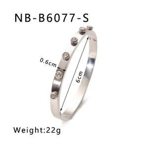 Close-up of a silver plated bangle with inlaid round zircons showing dimensions and weight