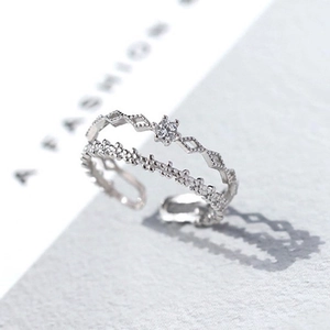 Detail shot of a double-layered hollow diamond silver ring on a white display card