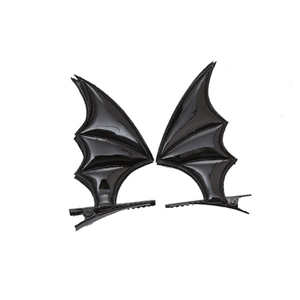 Close-up of black glossy bat wing hair clips with detailed stitching for Halloween costumes