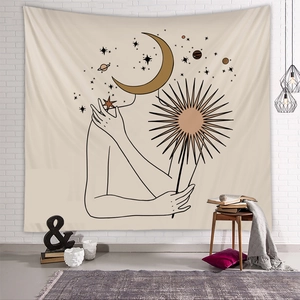 Detail of bohemian tapestry featuring moon and sun line art on a neutral fabric