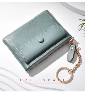 Detail of teal mini coin purse with gold keychain and secure snap button closure