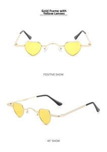 Detail view of heart-shaped sunglasses featuring gold metal frame and yellow lenses
