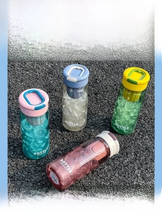Detail of portable water bottles with built-in tea infuser and handle in four colors