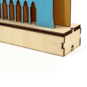 Detailed view of laser-cut wooden moon lamp with blue inserts and precise joints