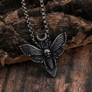 Retro stainless steel gothic moth skull pendant with metal chain on vintage wood