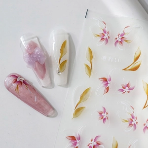 Floral nail art stickers with pink gradient flowers and gold leaves on clear background