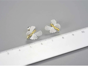 Macro view of butterfly ginkgo silver earrings with ruler showing 1.5cm width detail