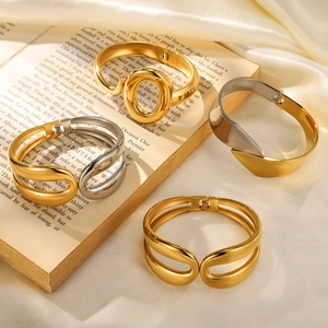 Minimalist spring open bangle in gold and silver finish on silk and book display