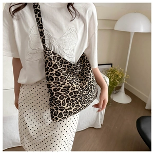 Shoulder bag detail showing leopard print pattern and soft canvas material texture