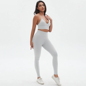 Detail view of seamless light grey yoga set with thin straps and high waist leggings