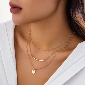 Three-layer gold layered necklace featuring a minimalist tube bar and round pendant