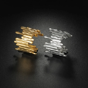 Artistic gold and silver molten lava textured titanium steel rings for women on black background