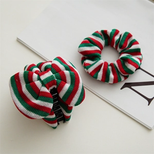 Detail of red and green striped knit velvet scrunchie and hair claw set for Christmas