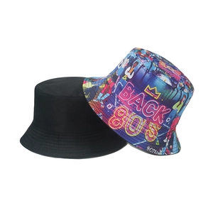 Detailed view of reversible bucket hat with vintage 80s graffiti and solid black side
