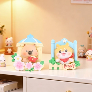 Detail of cartoon capybara and shiba inu resin figurines with warm pastel colors
