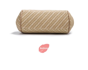 Detail view of the woven cylinder bag bottom with synthetic leather trim and bicolor pattern